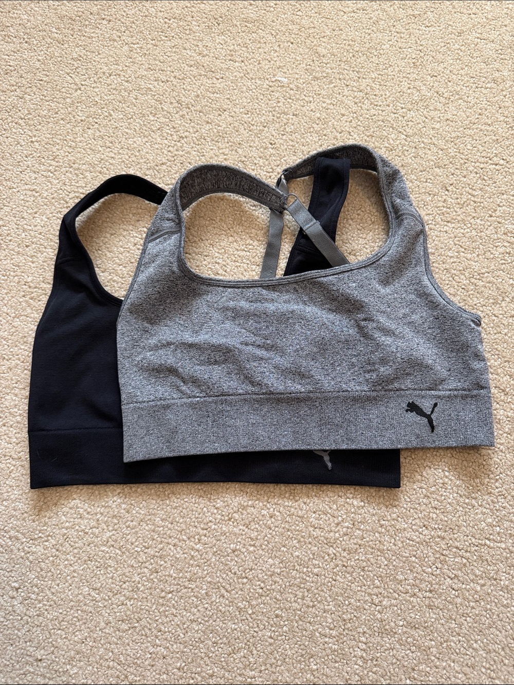 Puma sports bras. One Black and One Gray. 
Size L